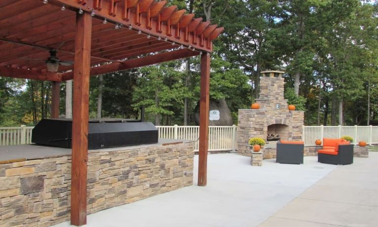 Outdoor furniture and grill area at Embassy Suites By Hilton Charlotte-Concord-Golf Resort & Spa.