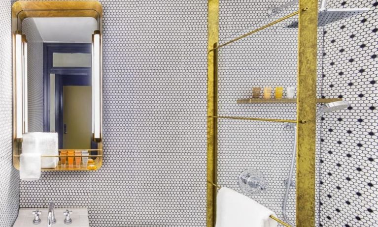Private guest bathroom with shower and free toiletries at Hotel Shocard NYC.