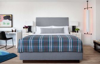 Day use room with king bed and work desk at Graduate New York.