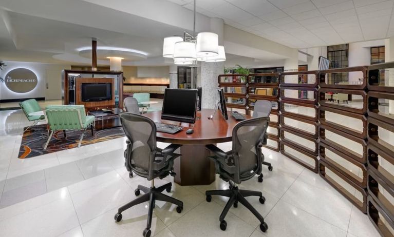 Business center with computers, printer and ergonomic chairs at Sheraton Miami Airport Hotel.