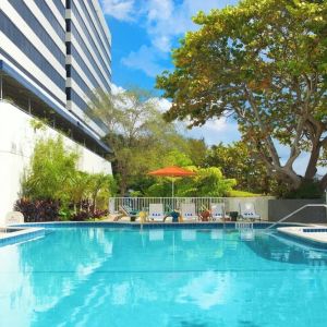 Outdoor pool with lounge chairs at Sheraton Miami Airport Hotel.