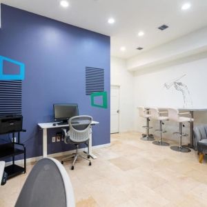 Business center with computers, printer and ergonomic chairs at Regency Miami Airport By Sonesta.