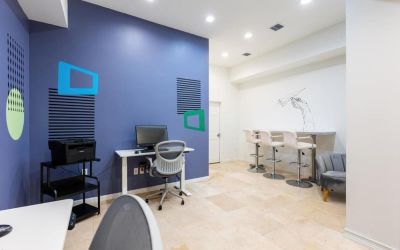 Business center with computers, printer and ergonomic chairs at Regency Miami Airport By Sonesta.