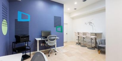 Business center with computers, printer and ergonomic chairs at Regency Miami Airport By Sonesta.