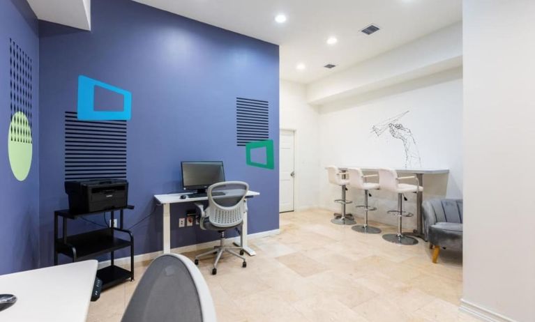 Business center with computers, printer and ergonomic chairs at Regency Miami Airport By Sonesta.