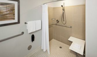 Private guest bathroom with accesible shower and free toiletries at Courtyard Miami Dolphin Mall.