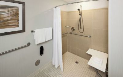Private guest bathroom with accesible shower and free toiletries at Courtyard Miami Dolphin Mall.