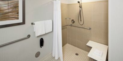 Private guest bathroom with accesible shower and free toiletries at Courtyard Miami Dolphin Mall.
