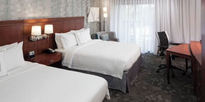 Day use twin room with large windows, work desk and private bathroom at Courtyard Miami Dolphin Mall.