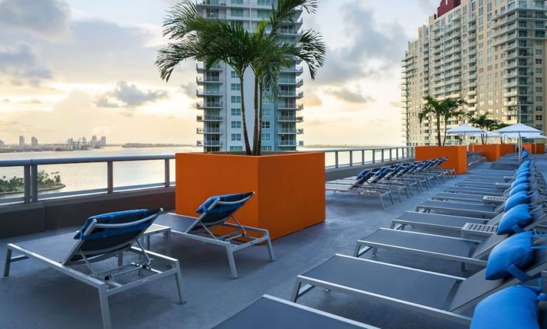 Rooftop terrace with lounge seating and beatiful seaside view at Hyatt Centric Brickell Miami.