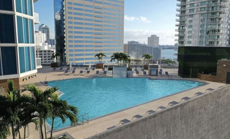 Rooftop pool with lounge chairs at Hyatt Centric Brickell Miami.