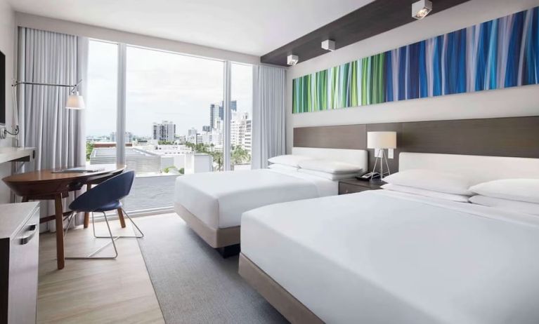 Day use twin room with floor to ceiling windows, work desk and private bathroom at Hyatt Centric Miami South Beach.