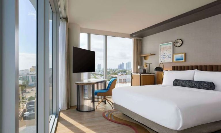 King room with floor to ceiling windows, work desk, TV screen and private bathroom at Hyatt Centric Miami South Beach.