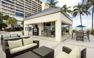 Hotel terrace with lounge seating at Hilton Miami Airport Blue Lagoon.