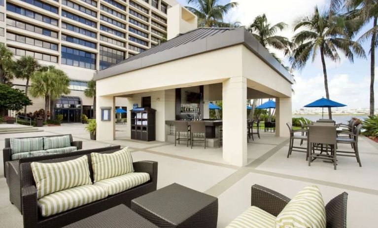 Hotel terrace with lounge seating at Hilton Miami Airport Blue Lagoon.