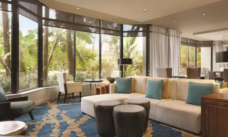 Hotel lobby with comfortable seating and workspace at Hilton Miami Airport Blue Lagoon.