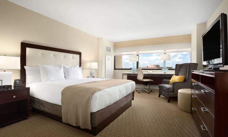 Day use room with work desk, TV screen, private bathroom and large windows at Hilton Miami Airport Blue Lagoon.