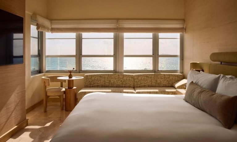 Day use room with king bed, large windows, lounge area and private bathroom at Shelborne South Beach.
