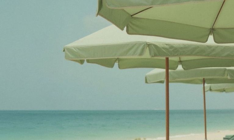Private beach access with lounge seating and umbrellas at Shelborne South Beach.