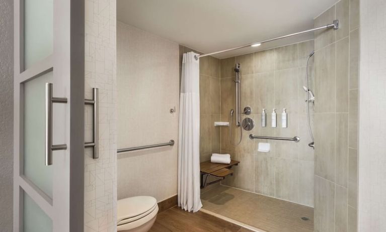 Private guest bathroom with shower and free toiletries at Embassy Suites By Hilton Miami - International Airport.