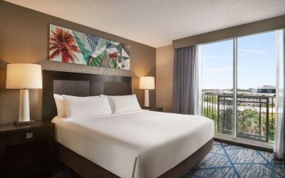 Day use room with large windows, king bed and private bathroom at Embassy Suites By Hilton Miami - International Airport.