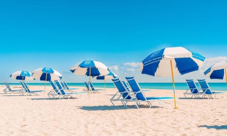 Beach access with lounge seating and umbrellas at The Goodtime Hotel.