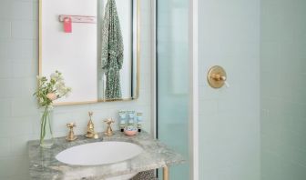 Private bathroom with shower and free toiletries at The Goodtime Hotel.