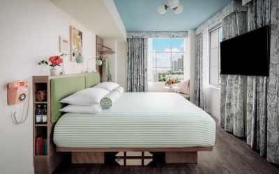 Day use room with king bed, TV screen, large windows and private bathroom at The Goodtime Hotel.
