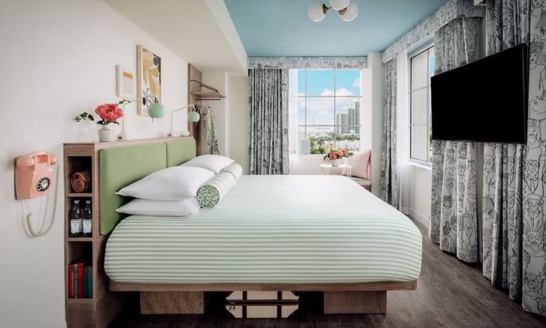Day use room with king bed, TV screen, large windows and private bathroom at The Goodtime Hotel.