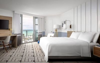 Day use room with king bed, work desk, balcony and private bathroom at Cadillac Hotel & Beach Club, Autograph Collection.