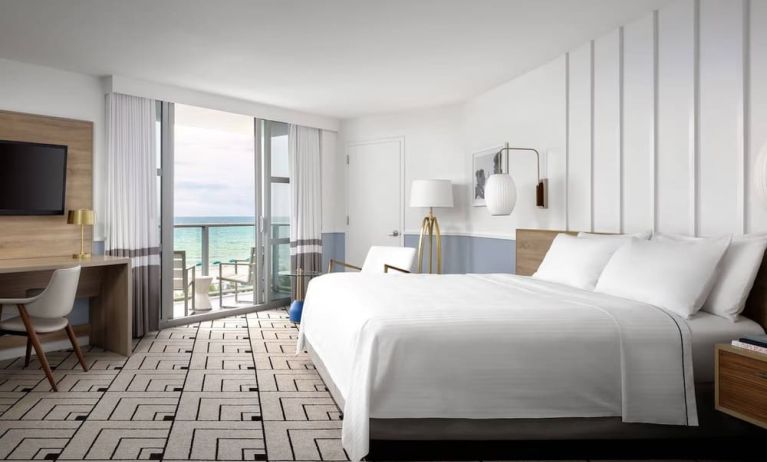 Day use room with king bed, work desk, balcony and private bathroom at Cadillac Hotel & Beach Club, Autograph Collection.