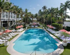 Beautiful outdoor pool with lounge chairs at Cadillac Hotel & Beach Club, Autograph Collection.