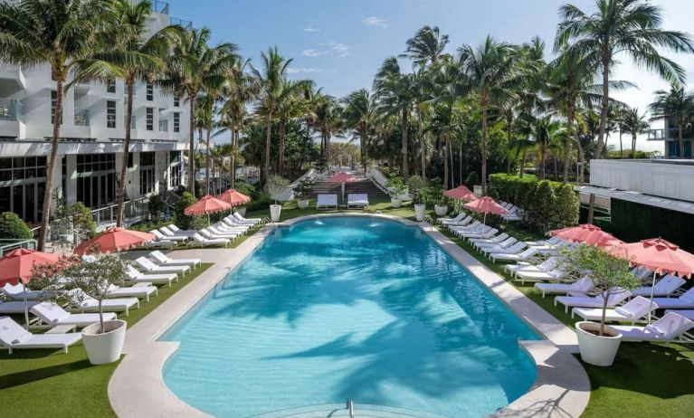 Beautiful outdoor pool with lounge chairs at Cadillac Hotel & Beach Club, Autograph Collection.