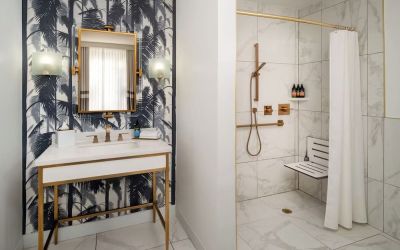 Accessible private guest bathroom with shower at Cadillac Hotel & Beach Club, Autograph Collection.