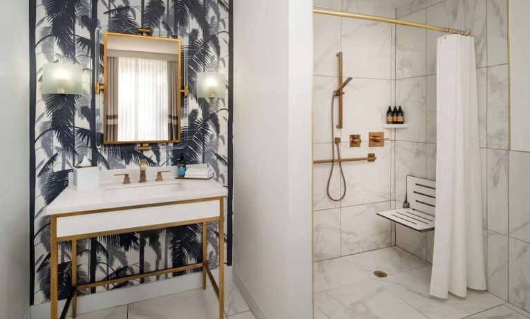Accessible private guest bathroom with shower at Cadillac Hotel & Beach Club, Autograph Collection.