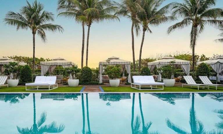 Outdoor pool with lounge seating at Cadillac Hotel & Beach Club, Autograph Collection.