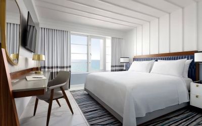 Day use room with king bed, large windows, work desk and private bathroom at Cadillac Hotel & Beach Club, Autograph Collection.