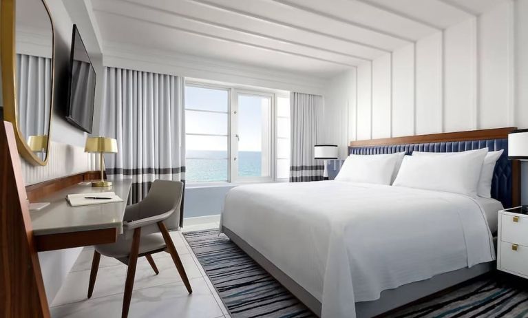 Day use room with king bed, large windows, work desk and private bathroom at Cadillac Hotel & Beach Club, Autograph Collection.