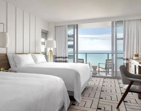 Day use twin room with work desk, balcony and private guest bathroom at Cadillac Hotel & Beach Club, Autograph Collection.