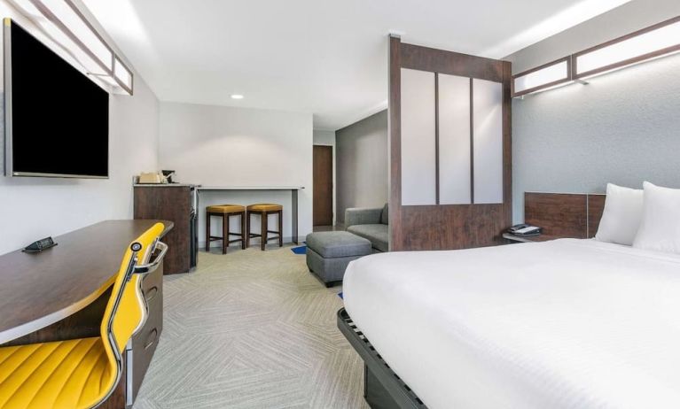 Day use room with TV and work desk at Microtel Inn And Suites By Wyndham Austin Airport.