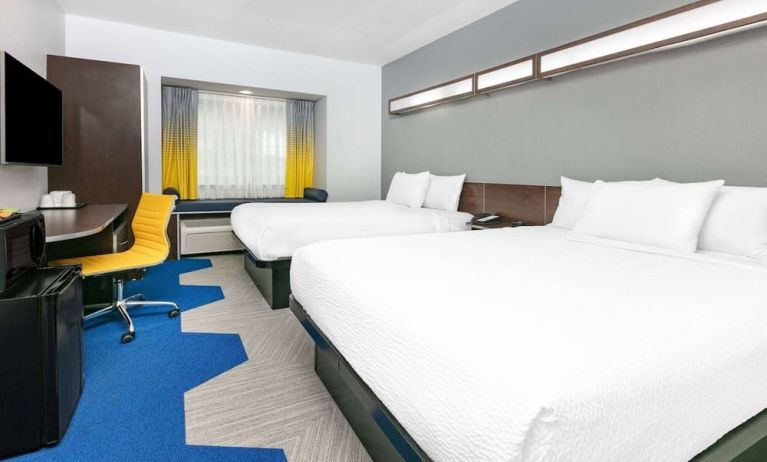 Day use room with TV and work desk at Microtel Inn And Suites By Wyndham Austin Airport.