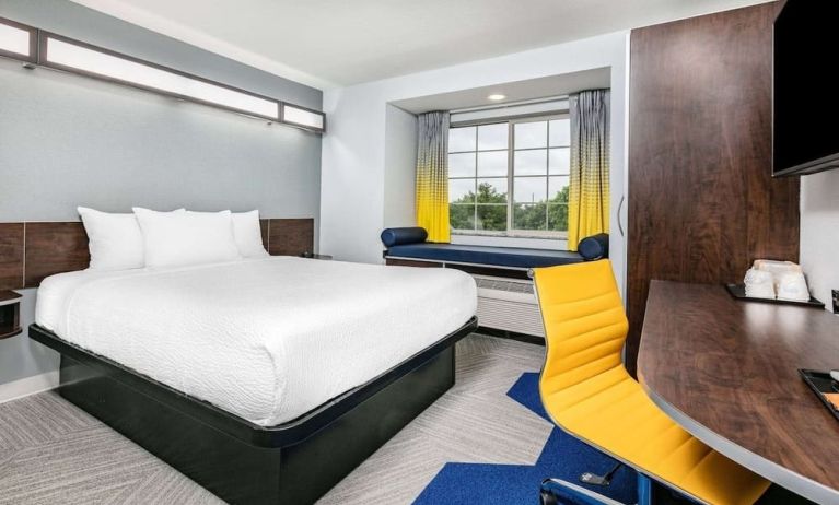 Day use room with TV and work desk at Microtel Inn And Suites By Wyndham Austin Airport.