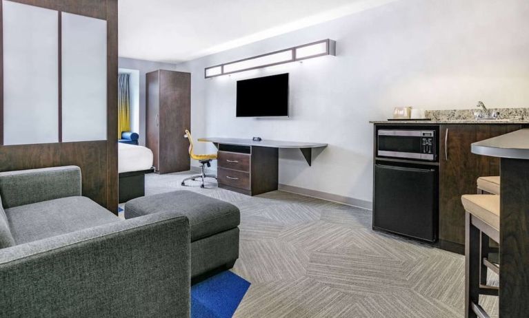 Day use room with TV and work desk at Microtel Inn And Suites By Wyndham Austin Airport.