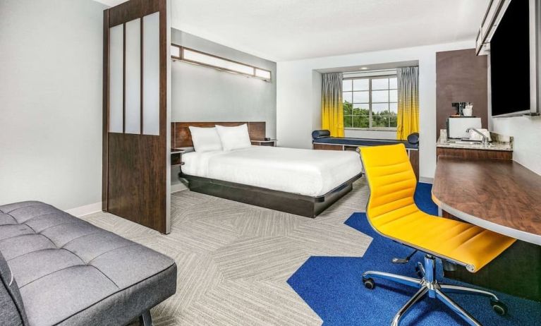 Day use room with TV and work desk at Microtel Inn And Suites By Wyndham Austin Airport.