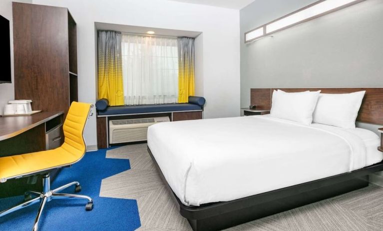 Day use room with TV and work desk at Microtel Inn And Suites By Wyndham Austin Airport.