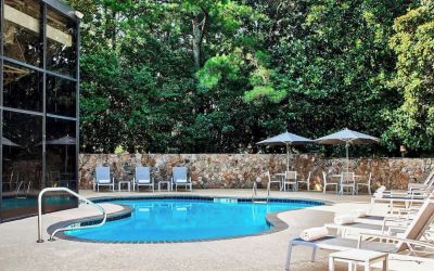 Refreshing outdoor pool surrounded with loungers at Westin Atlanta Airport Hotel.