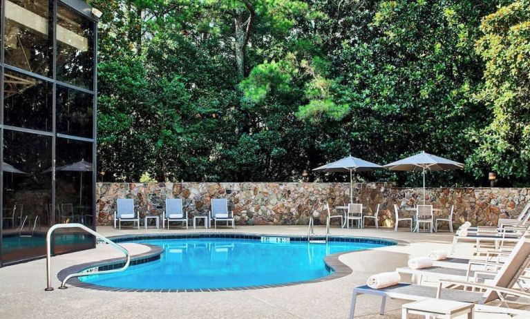 Refreshing outdoor pool surrounded with loungers at Westin Atlanta Airport Hotel.