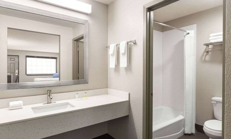 Guest bathroom at Days Inn By Wyndham San Antonio Near Fiesta Park.
