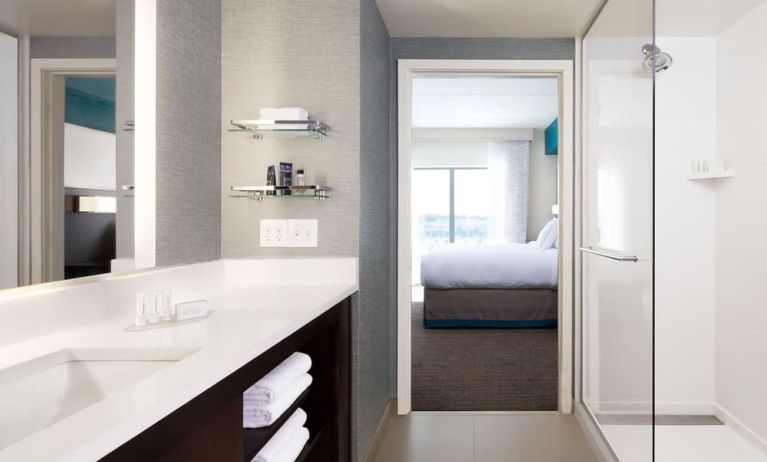 Private guest bathroom with shower and free toiletries at Residence Inn By Marriott LAX Airport.