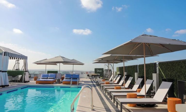 Relaxing outdoor pool with lounge chairs at Montrose At Beverly Hills.